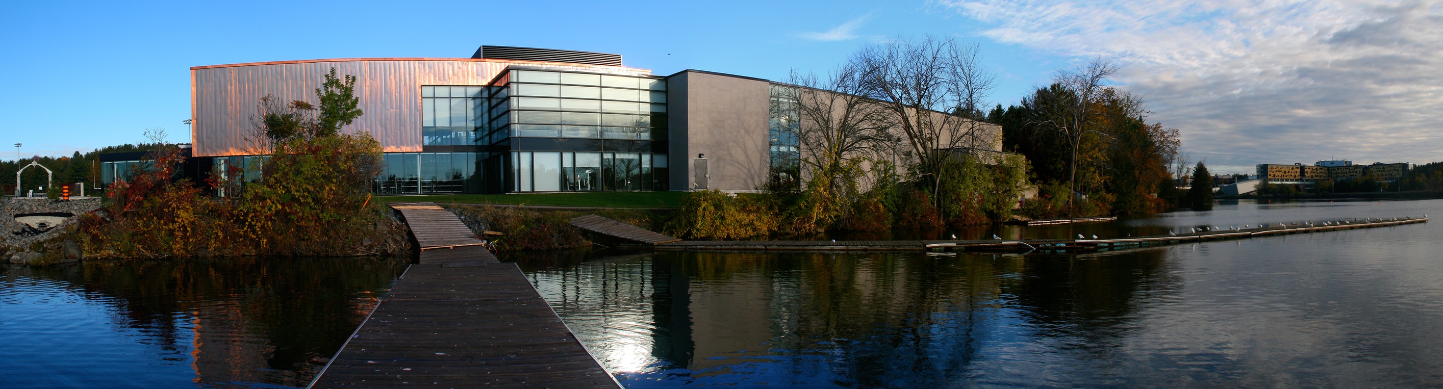 A wide angle shot of the Trent Athletics Centre taken from the end of a long dock on the Trent Severn Waterway. 
